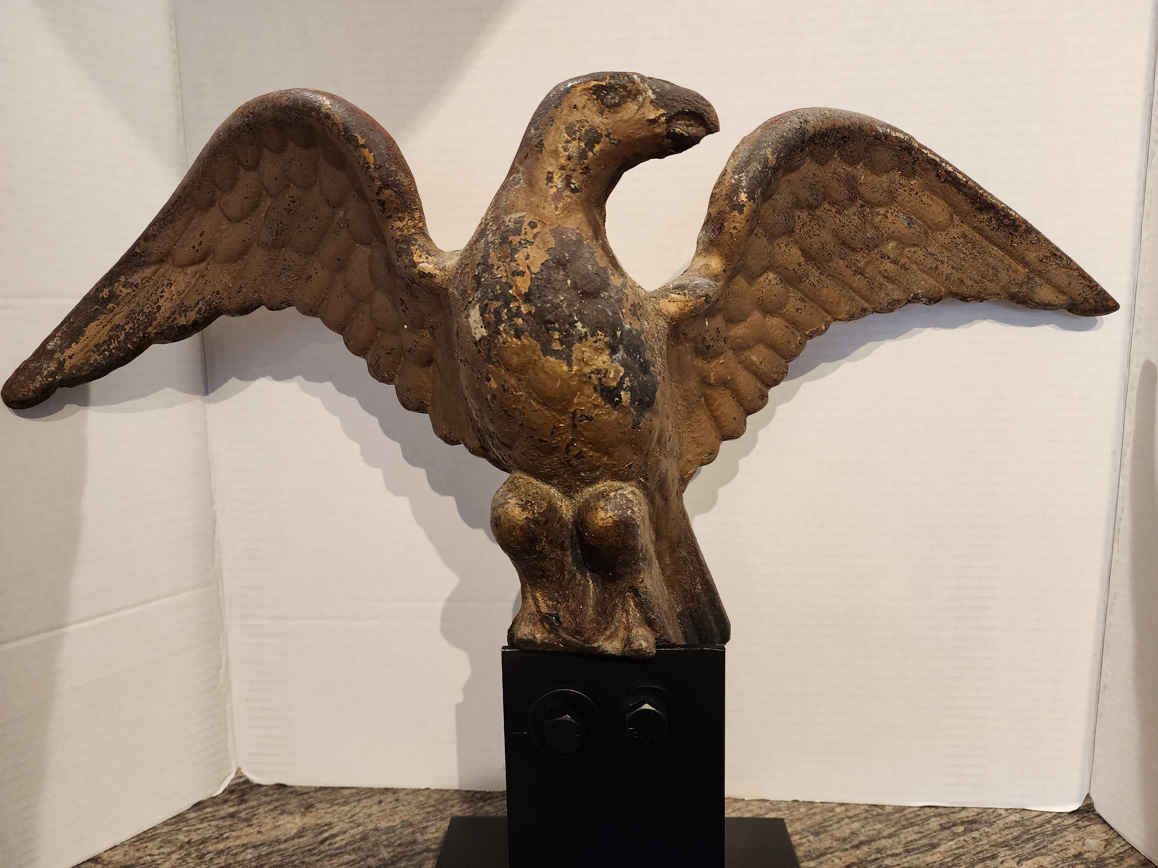 A CAST IRON EAGLE FINIAL IN OLD PAINT