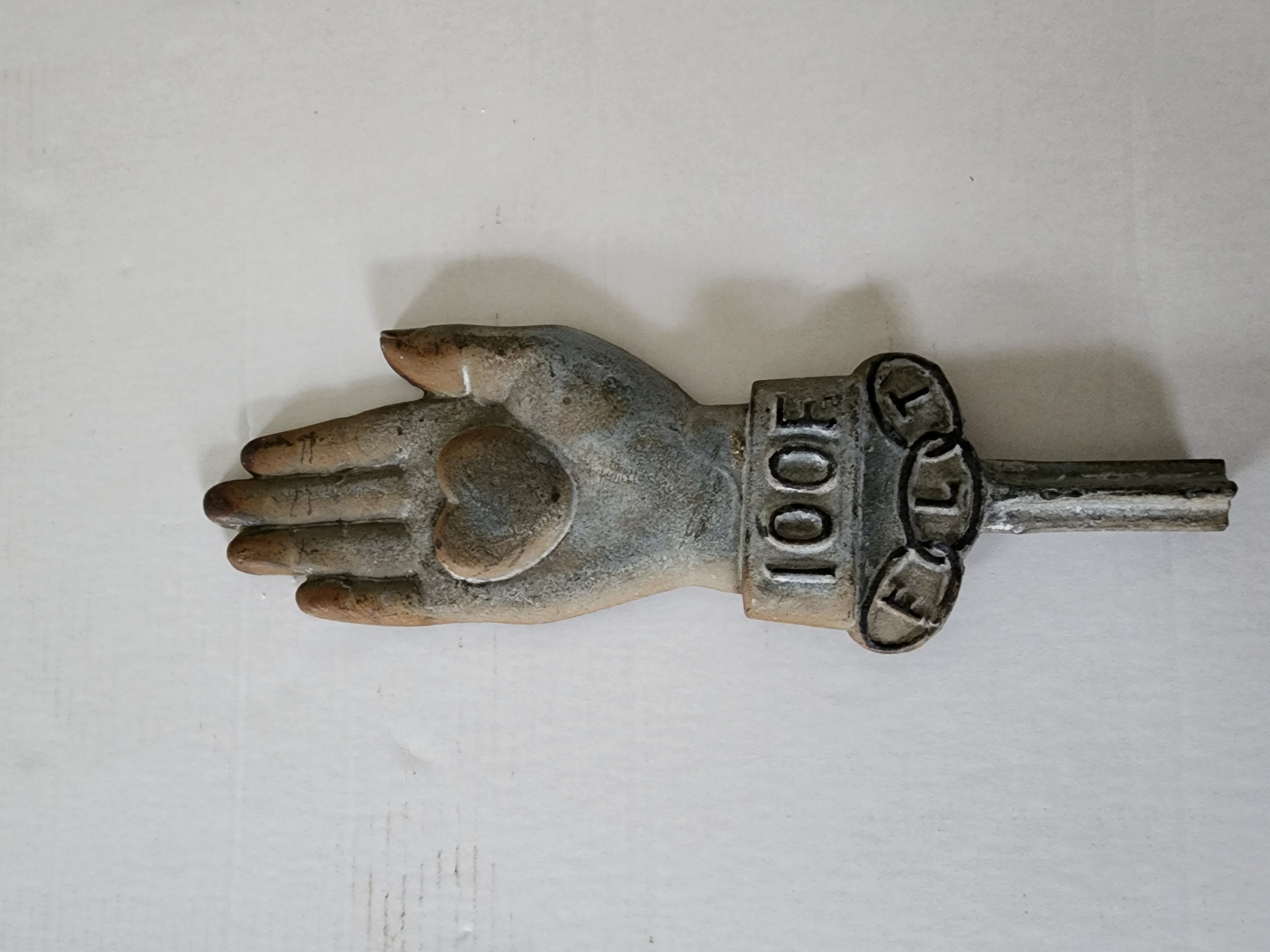 CAST IRON HAND, WITH A HEART ON HAND..